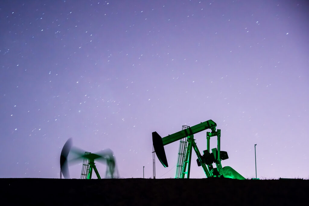 Photo of oil wells in the evening - purple sky.